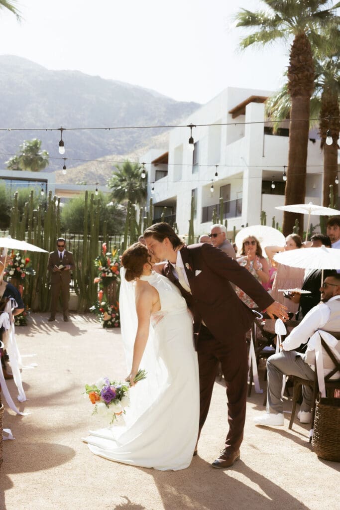 Bride and groom exchanging vows during a modern desert wedding ceremony at The Drift Palm Springs.