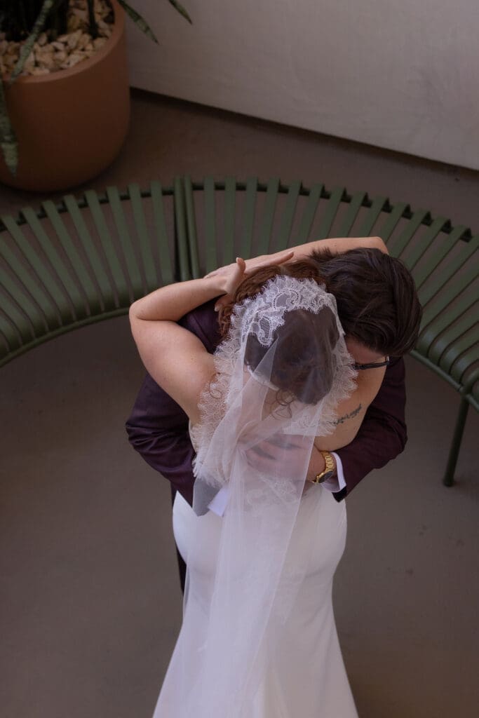 Bride and groom embracing during their first look at The Drift Palm Springs in Palm Springs.