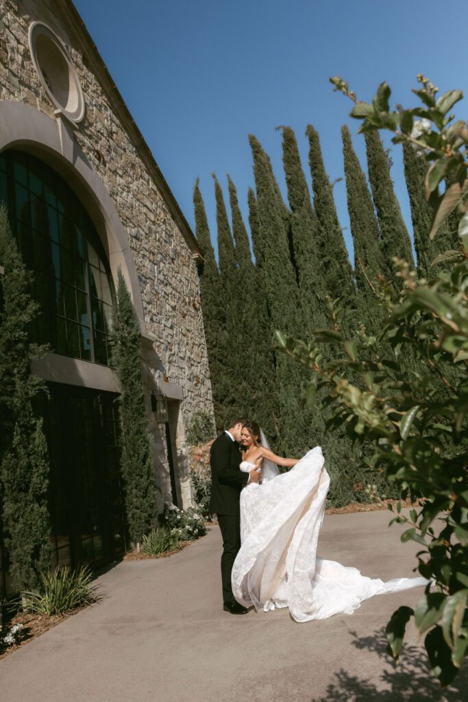 Bride and groom walking through the vineyards at Monserate Winery during sunset wedding portraits.